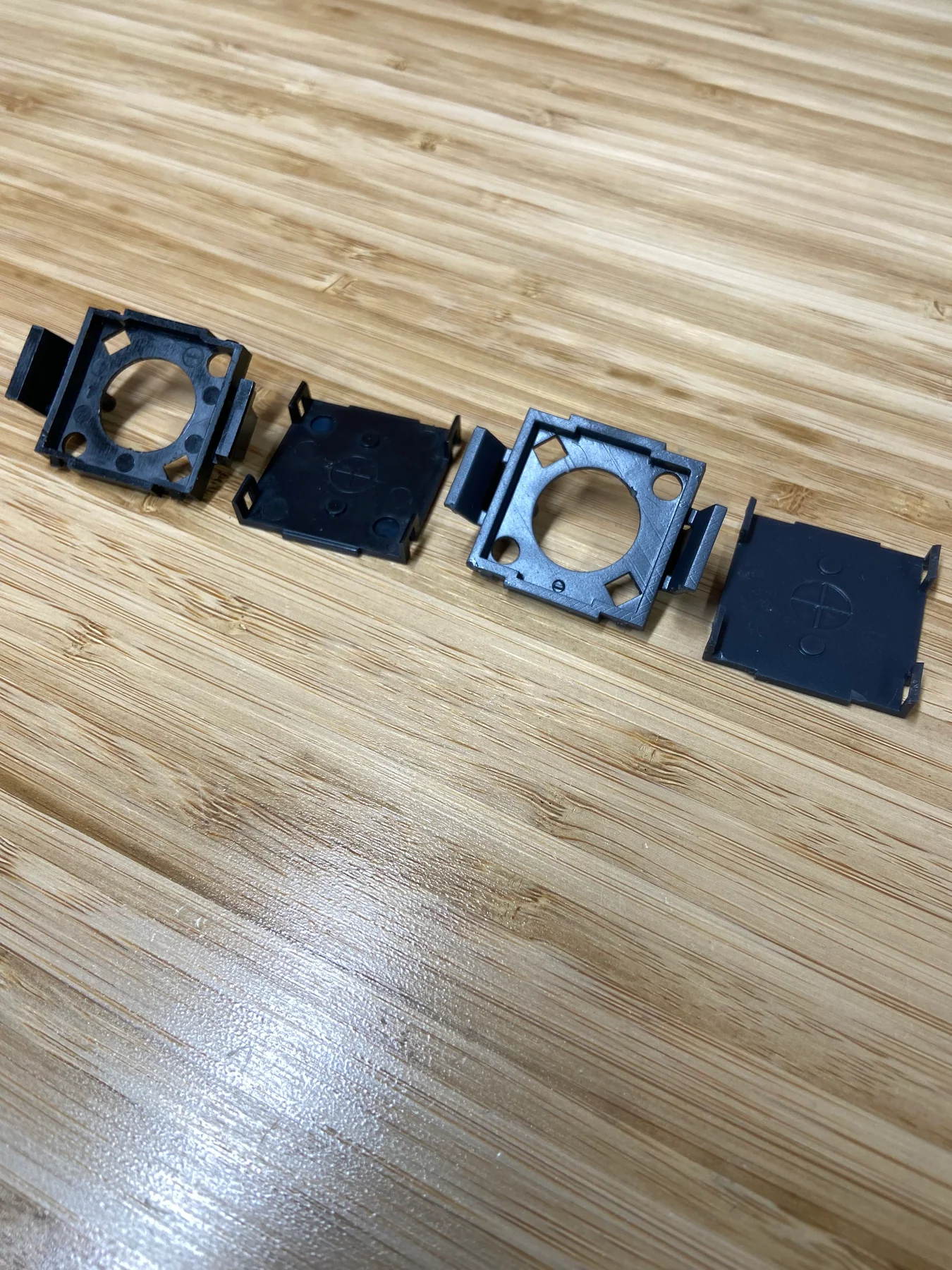 Original battery tray base and cover laid out beside the 3D-printed replacement components