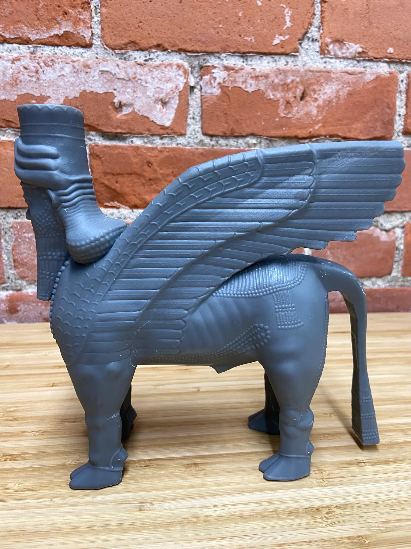Rear three-quarter view of the lamassu print showing layered wing feathers