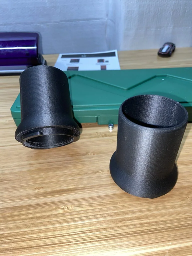 Two black printed cylindrical adapter sleeves