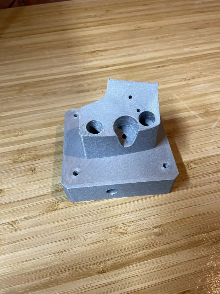 Gray 3D-printed mounting bracket with counterbored holes